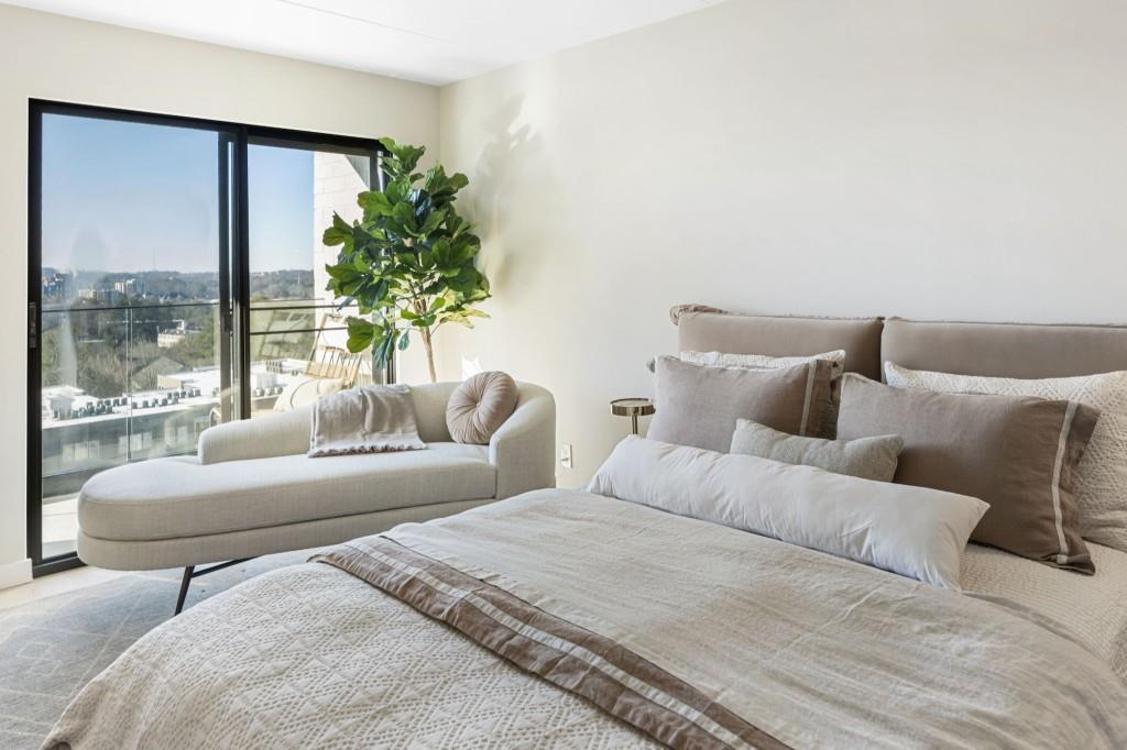 2460 Peachtree Road Northeast, Unit 514 Atlanta, GA 30305 - Photo 23 of 36 a living room with a large window and a couch