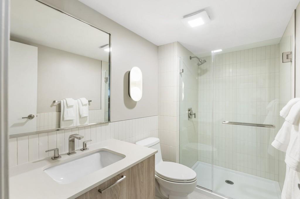 2460 Peachtree Road Northeast, Unit 514 Atlanta, GA 30305 - Photo 25 of 36 a bathroom with a sink a toilet and shower