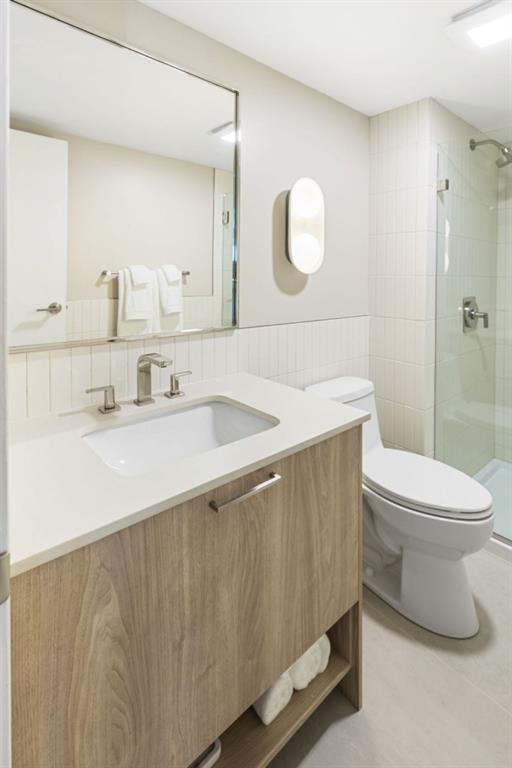 2460 Peachtree Road Northeast, Unit 514 Atlanta, GA 30305 - Photo 26 of 36 a bathroom with a sink a toilet and mirror