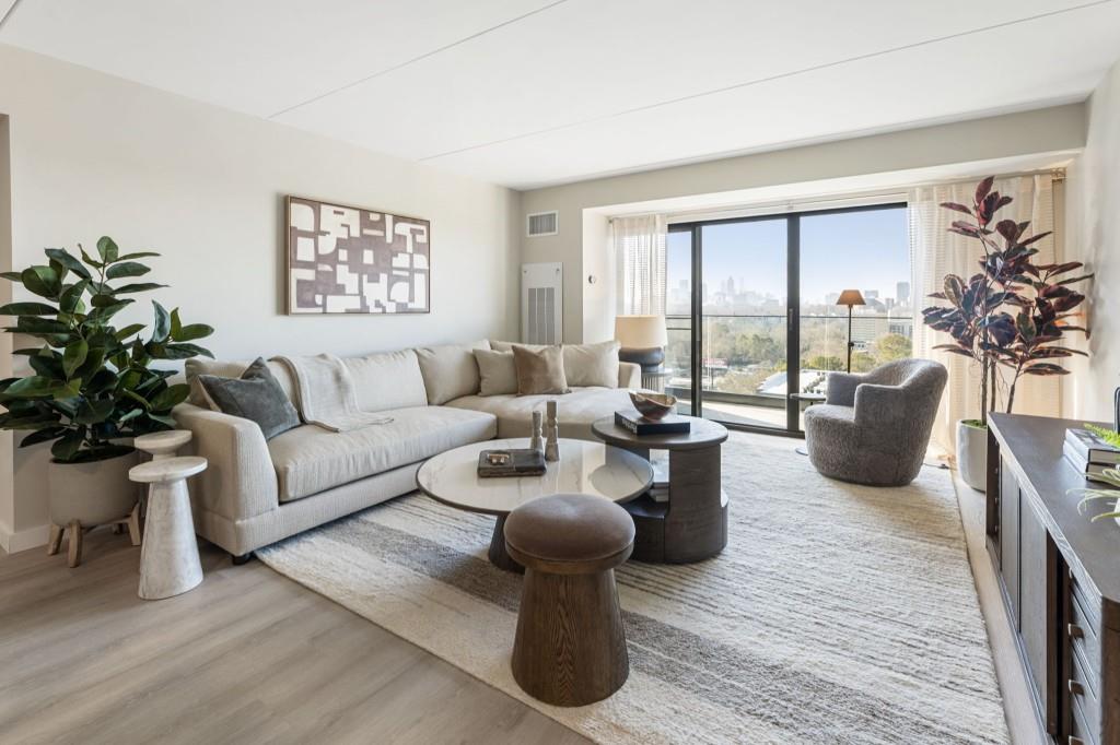2460 Peachtree Road Northeast, Unit 514 Atlanta, GA 30305 - Photo 9 of 36 a living room with furniture potted plant and a large window