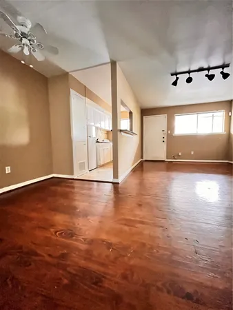 a view of a room with wooden floor