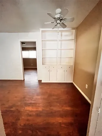 an empty room with a empty space and a ceiling fan