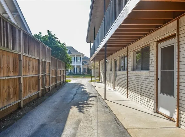 a view of a house with backyard and wooden fence