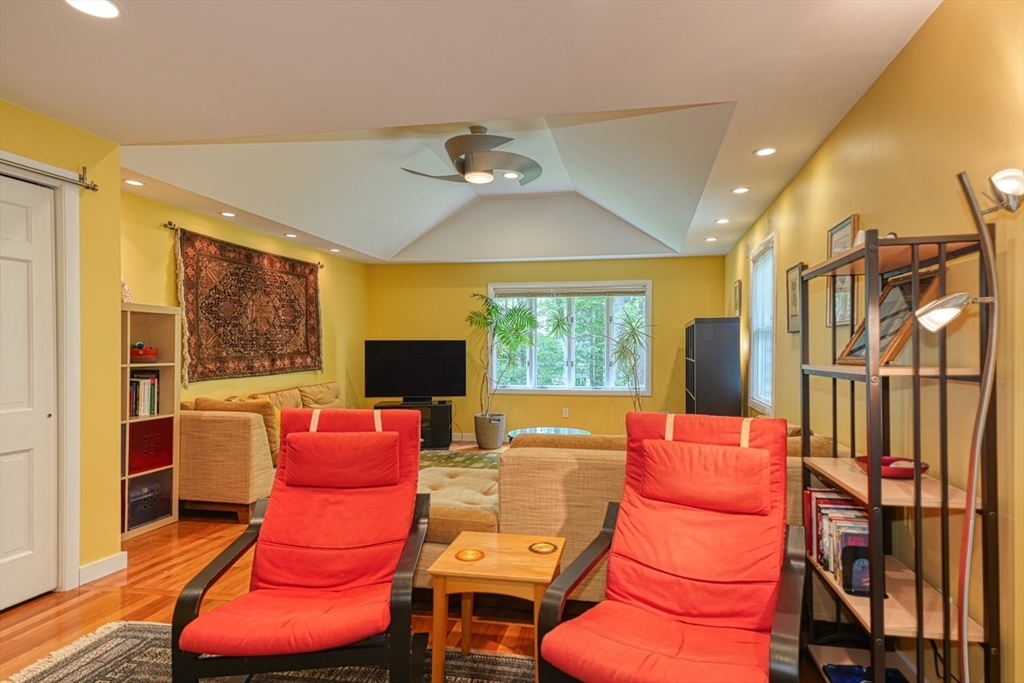 27 Wheeler Road Westborough, MA 01581 - Photo 12 of 41 a living room with furniture a fireplace and a flat screen tv