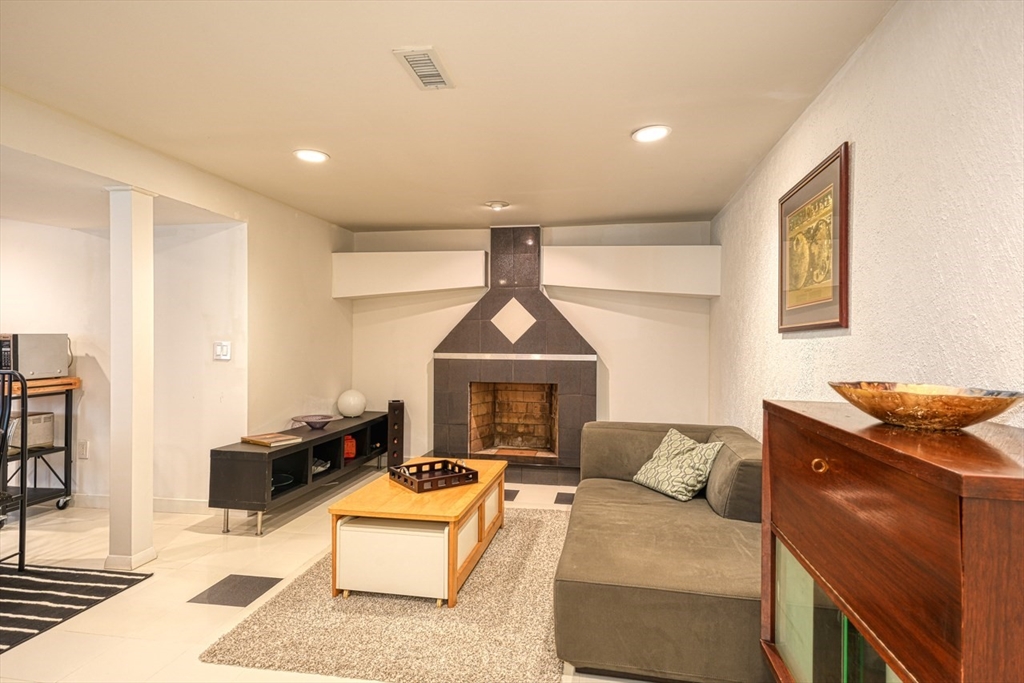 27 Wheeler Road Westborough, MA 01581 - Photo 26 of 41 a living room with furniture a fireplace and a flat screen tv