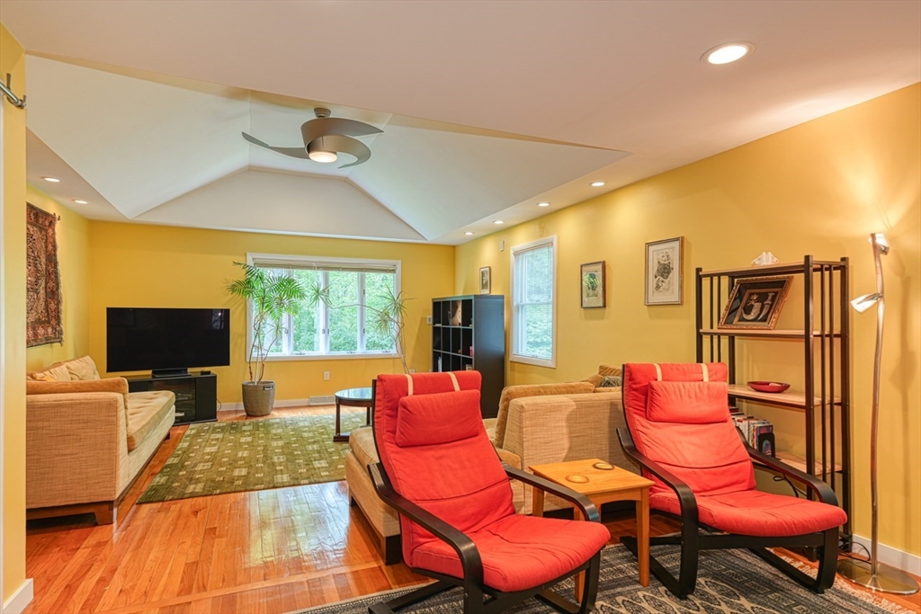 27 Wheeler Road Westborough, MA 01581 - Photo 8 of 41 a living room with furniture a flat screen tv and wooden floor