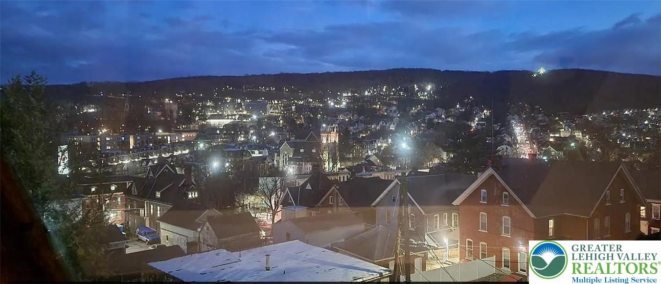 444 West 3rd Street, Unit 9 Bethlehem, PA 18015 - Photo 16 of 16 A captivating cityscape view reveals twinkling lights across a vast hilly landscape at dusk.