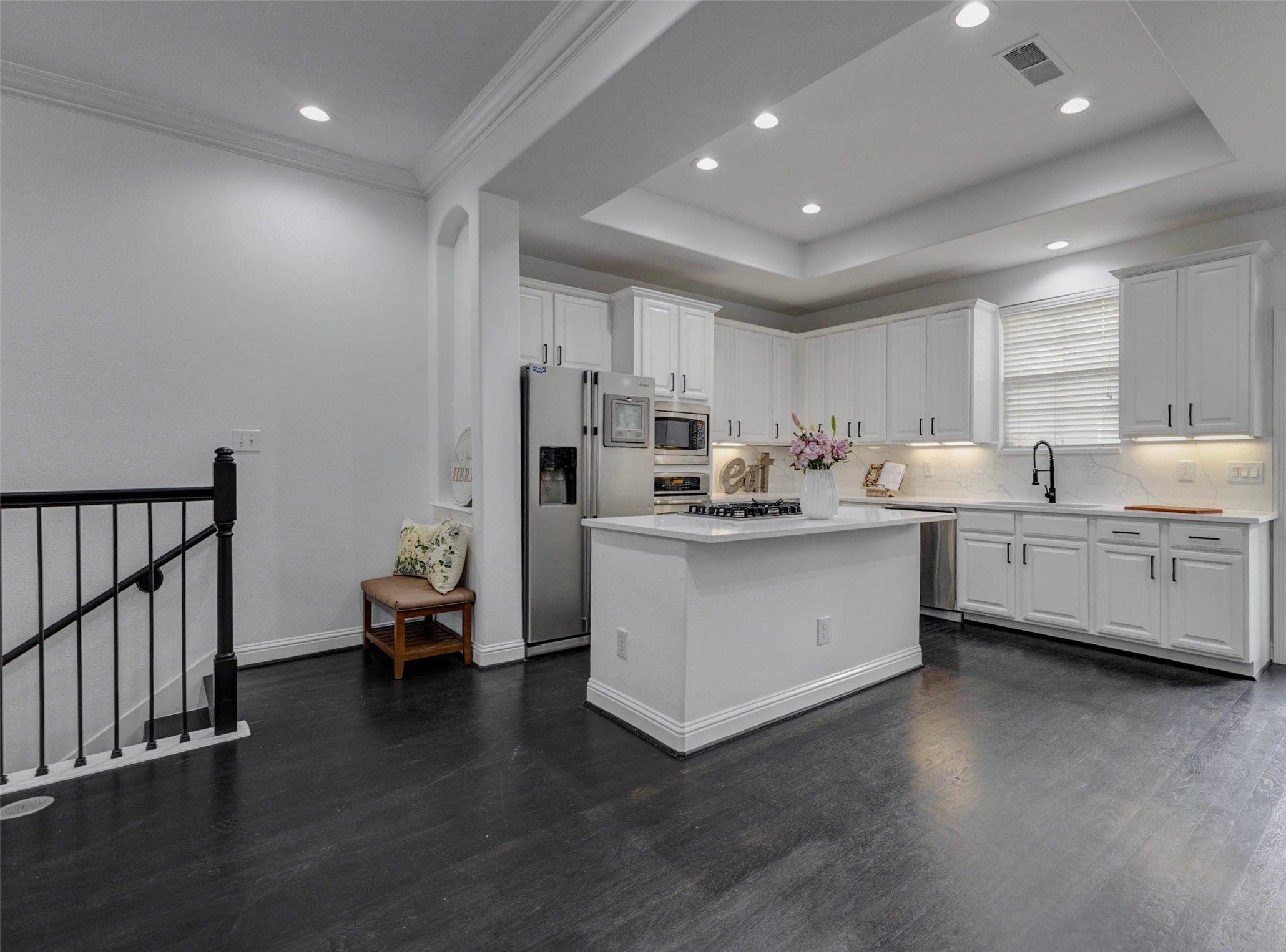 19 Versante Court Houston, TX 77070 - Photo 8 of 40 This home features so many UPDATES: including paint, Quartz counter tops and backsplash, lights, hardware, sink, faucet, and NO CARPET!!