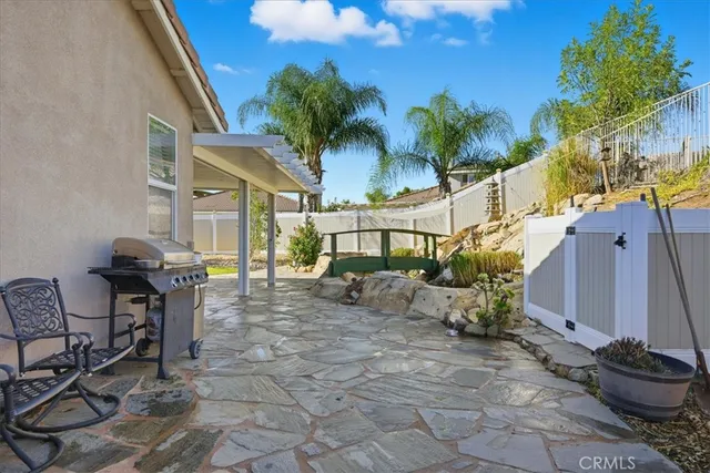 a view of a patio with table and chairs and potted plants