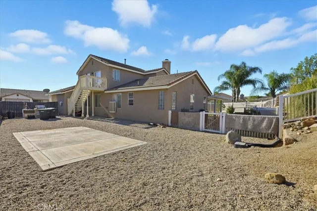 a view of a house with wooden fence