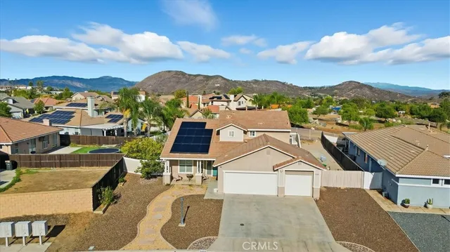 an aerial view of residential houses with a city view