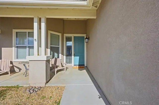 a view of a patio with a table and chairs