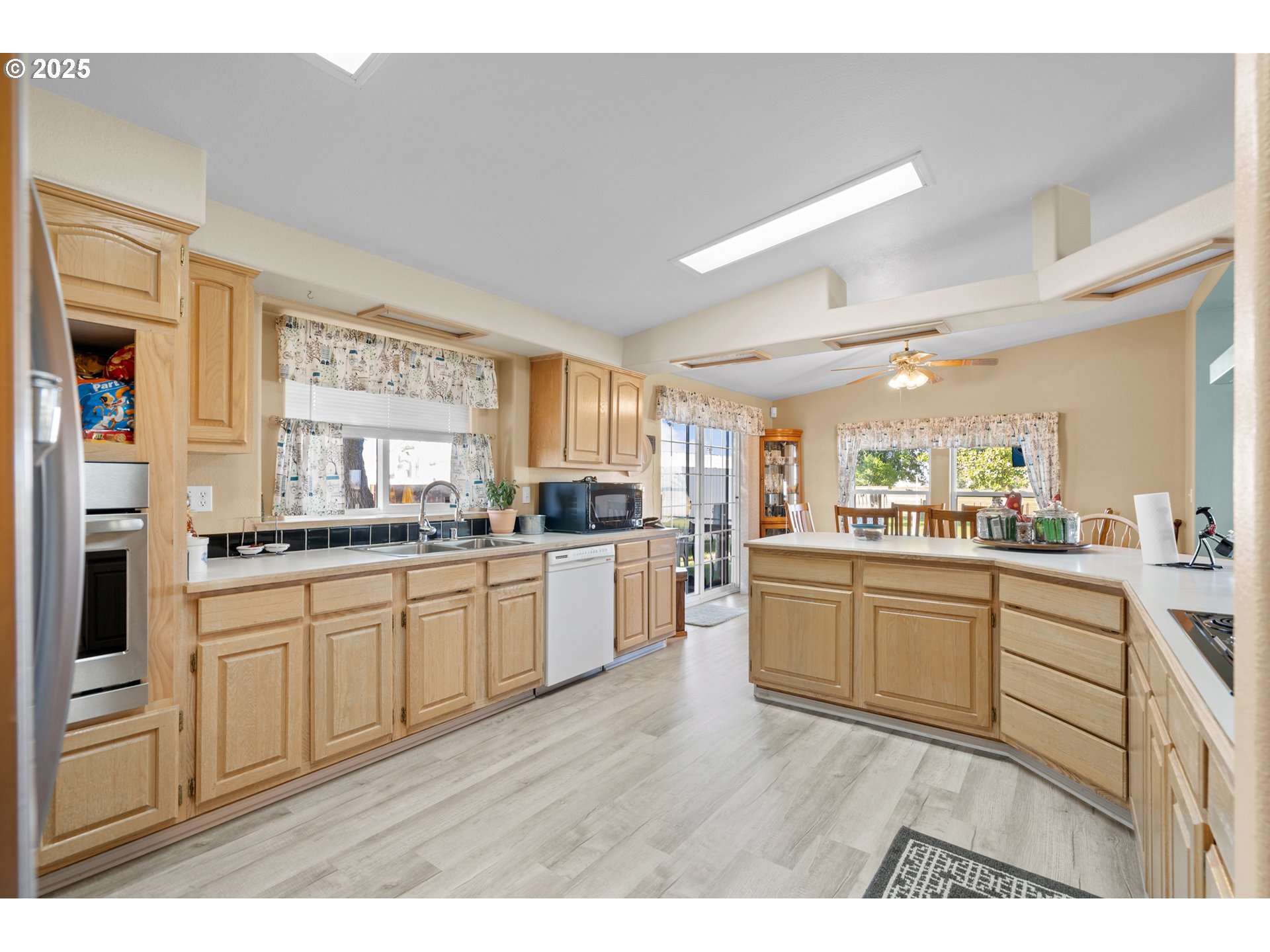 34656 County 1172 Road Stanfield, OR 97875 - Photo 3 of 48 a kitchen with granite countertop white cabinets a sink a window and stainless steel appliances