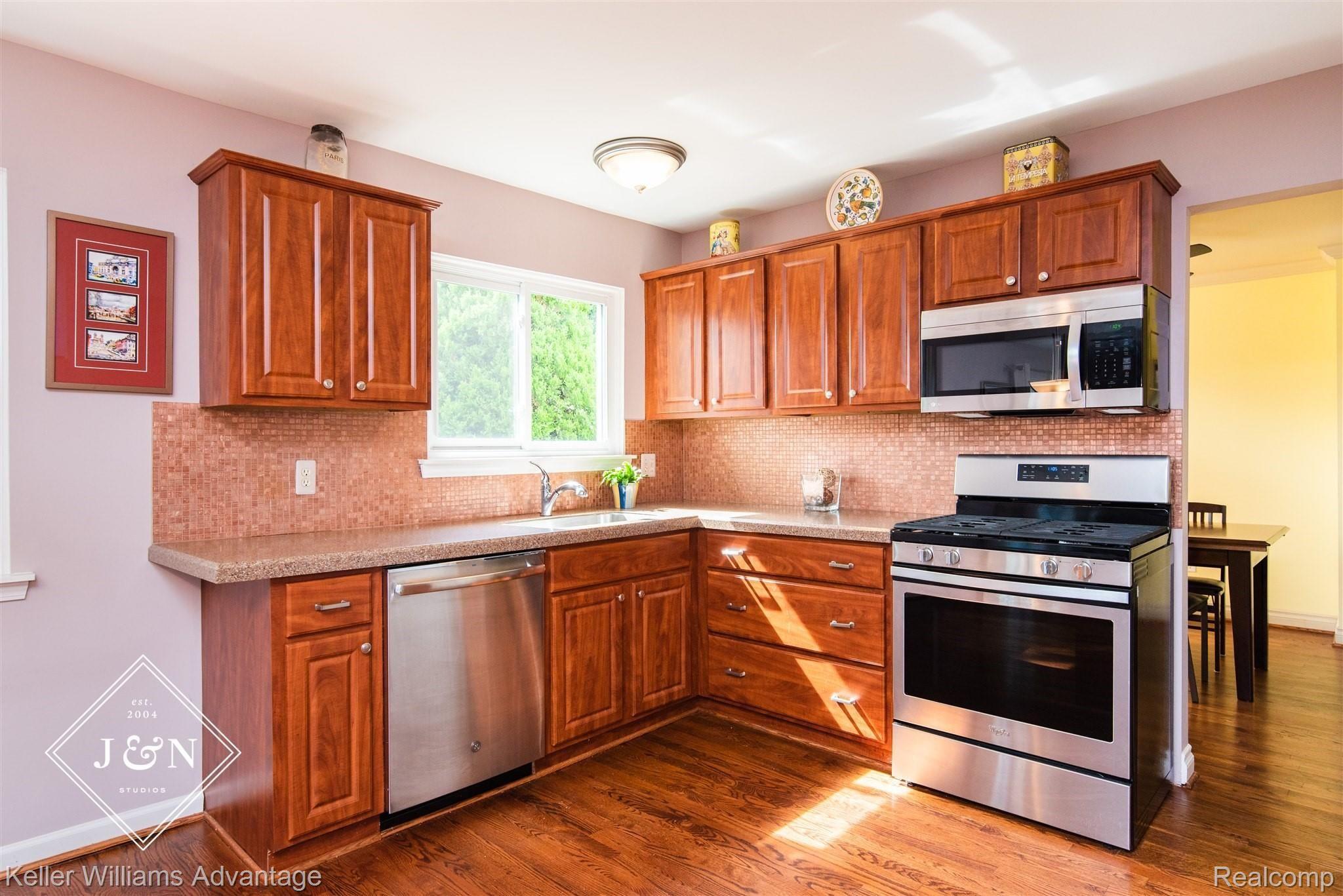 42209 Park Ridge Road Novi, MI 48375 - Photo 6 of 17 Natural light abounds. Beautiful Tile Backsplash and Newer Appliances