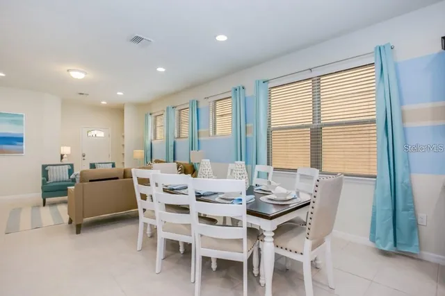 a view of a dining room with furniture and window
