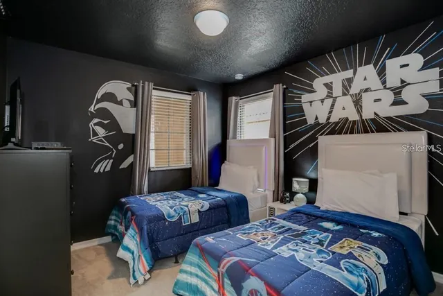 a bedroom with two beds and a window