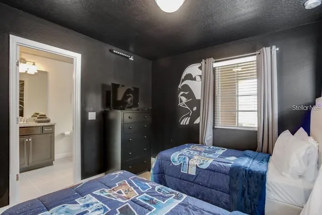 a bedroom with a bed and a mirror