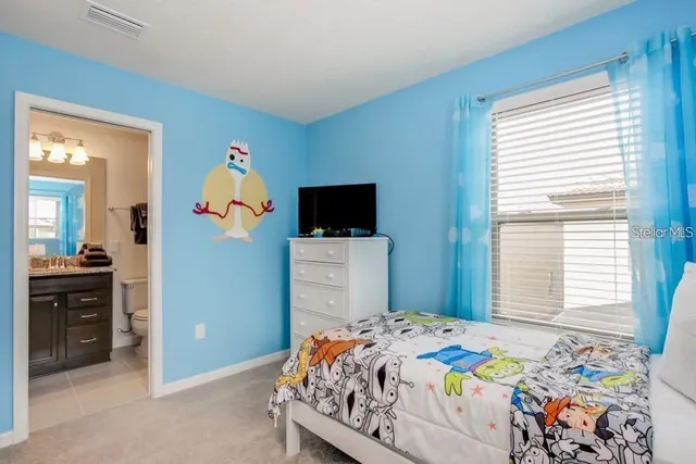 a bedroom with a bed and flat screen tv