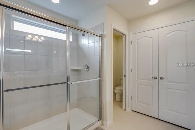 a bathroom with a glass shower door