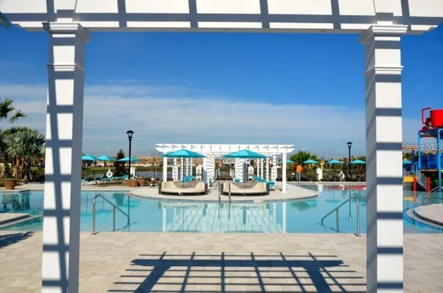 a view of swimming pool with outdoor seating