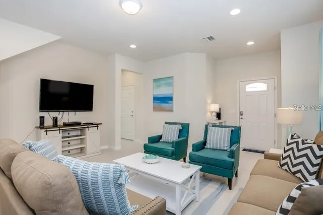 a living room with furniture and a flat screen tv