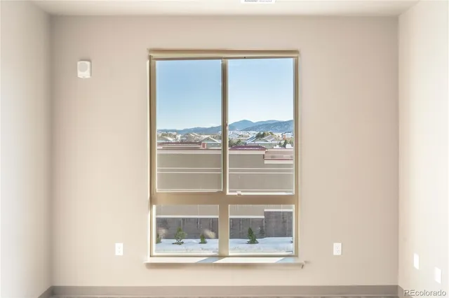 a view of a room that has a glass door and a window