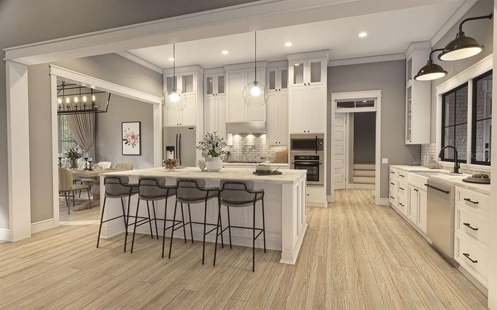 34710 Clayton Road Dade City, FL 33523 - Photo 14 of 17 a kitchen with stainless steel appliances kitchen island granite countertop a table chairs sink and cabinets