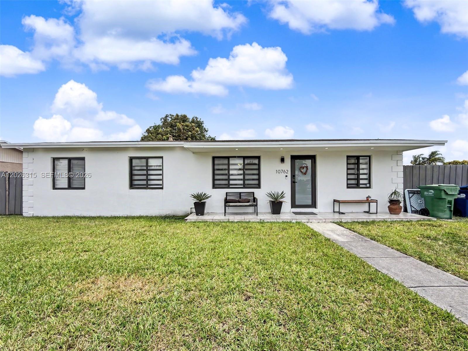 10762 Southwest 145th Street Miami, FL 33176 - Photo 6 of 28 a front view of a house with a garden