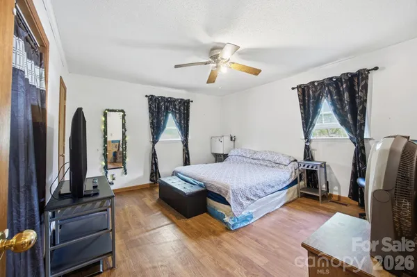 a bedroom with a bed and a chandelier