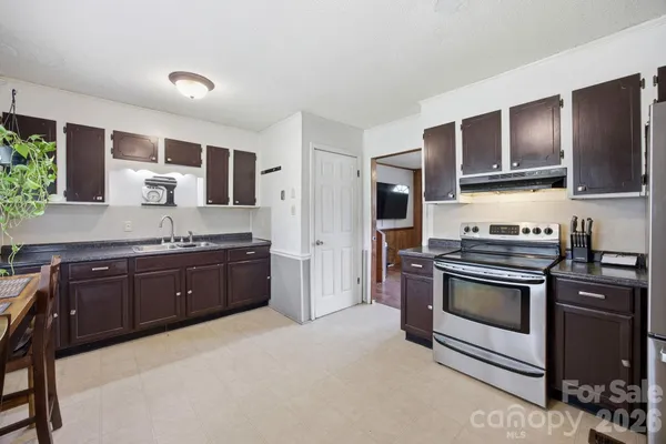 a kitchen with stainless steel appliances granite countertop a stove and a sink