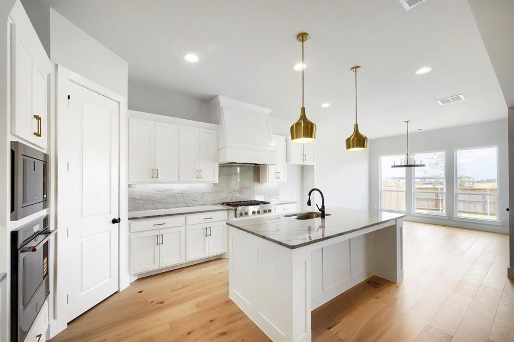 799 Mandrake Road Haslet, TX 76052 - Photo 6 of 27 a kitchen with a sink stove and wooden floor