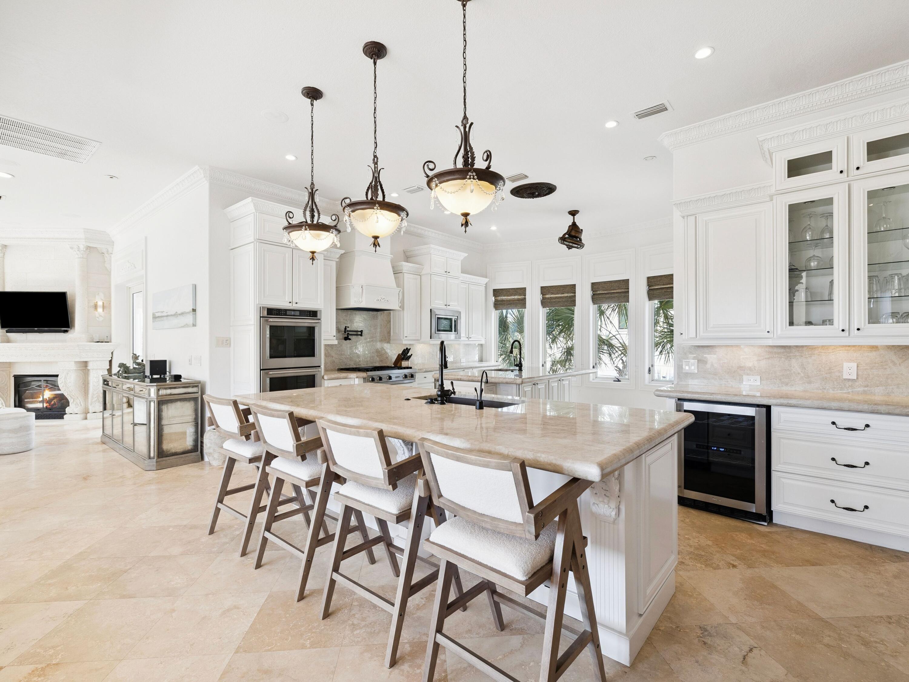 30 Pelican Circle Inlet Beach, FL 32461 - Photo 15 of 48 a kitchen with stainless steel appliances kitchen island granite countertop a table chairs and a view of living room