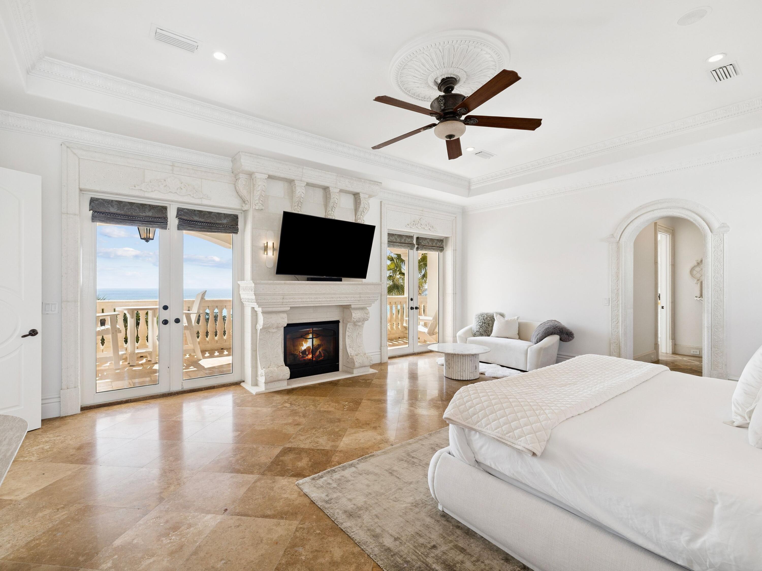 30 Pelican Circle Inlet Beach, FL 32461 - Photo 21 of 48 a spacious bedroom with a large bed a flat tv screen and a fireplace with wooden floor