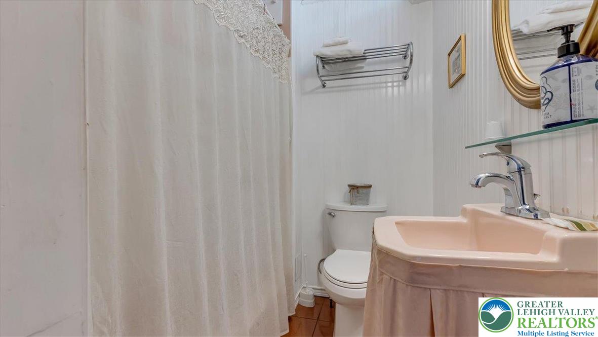 12 Chestnut Avenue Jim Thorpe, PA 18229 - Photo 23 of 38 a bathroom with a sink a toilet and shower curtain