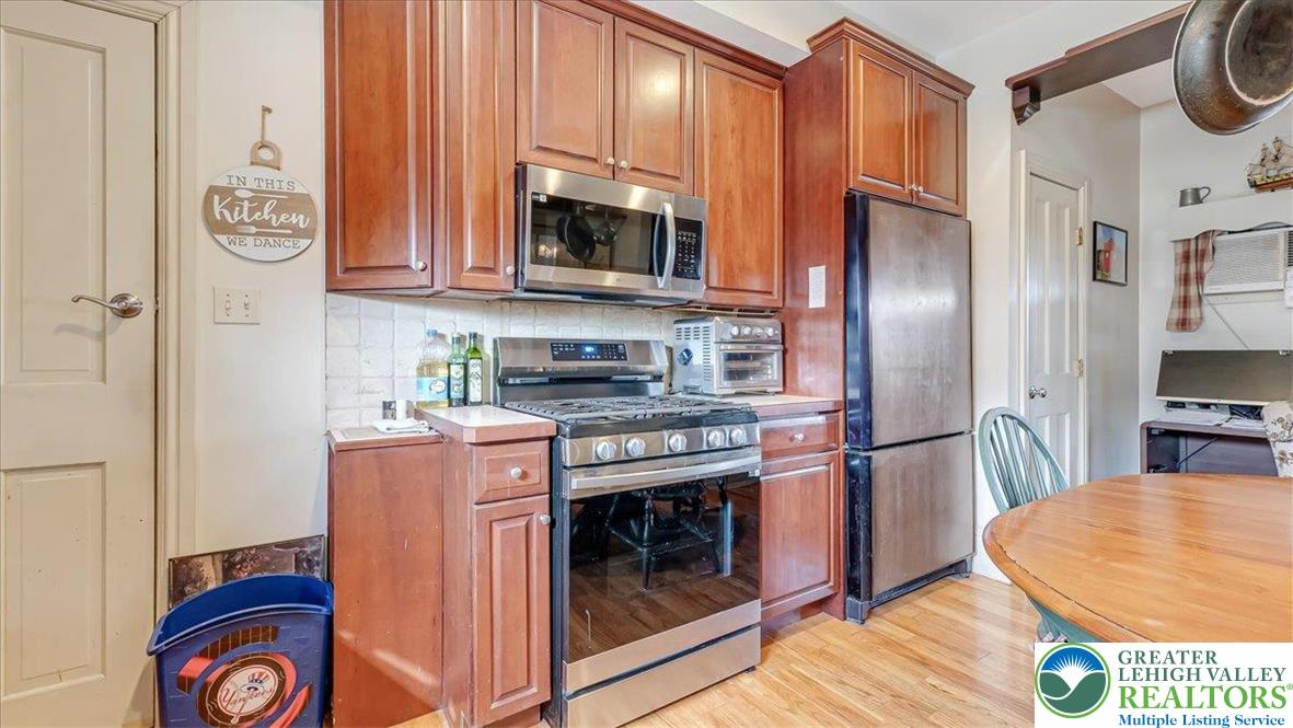 12 Chestnut Avenue Jim Thorpe, PA 18229 - Photo 6 of 38 a kitchen with stainless steel appliances granite countertop a refrigerator a stove and a wooden floor