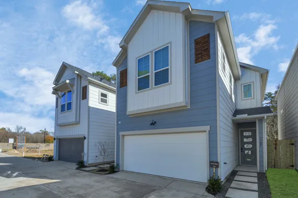 a front view of a house with a parking space