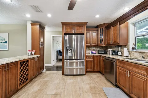 a bathroom with a granite countertop double vanity sink and a mirror