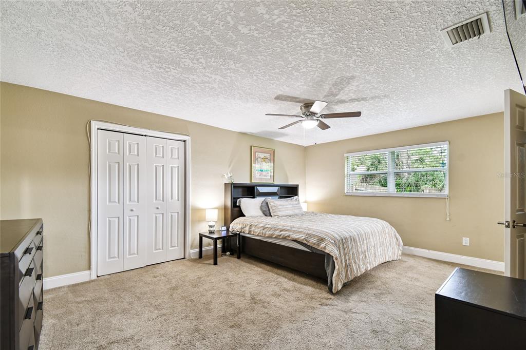 1948 Belleair Road Clearwater, FL 33764 - Photo 22 of 84 a spacious bedroom with a bed and a window