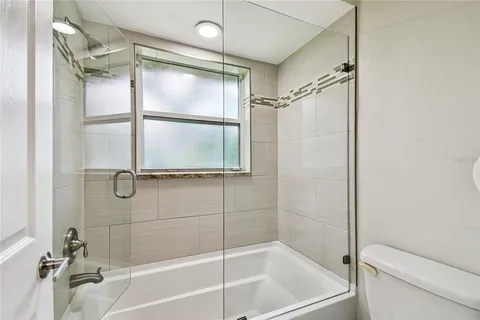 a kitchen with stainless steel appliances granite countertop a refrigerator and a stove