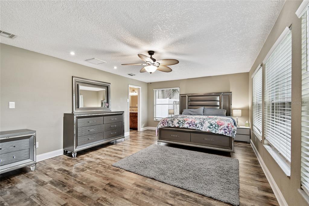 1948 Belleair Road Clearwater, FL 33764 - Photo 38 of 84 a bedroom with a large bed and a chandelier