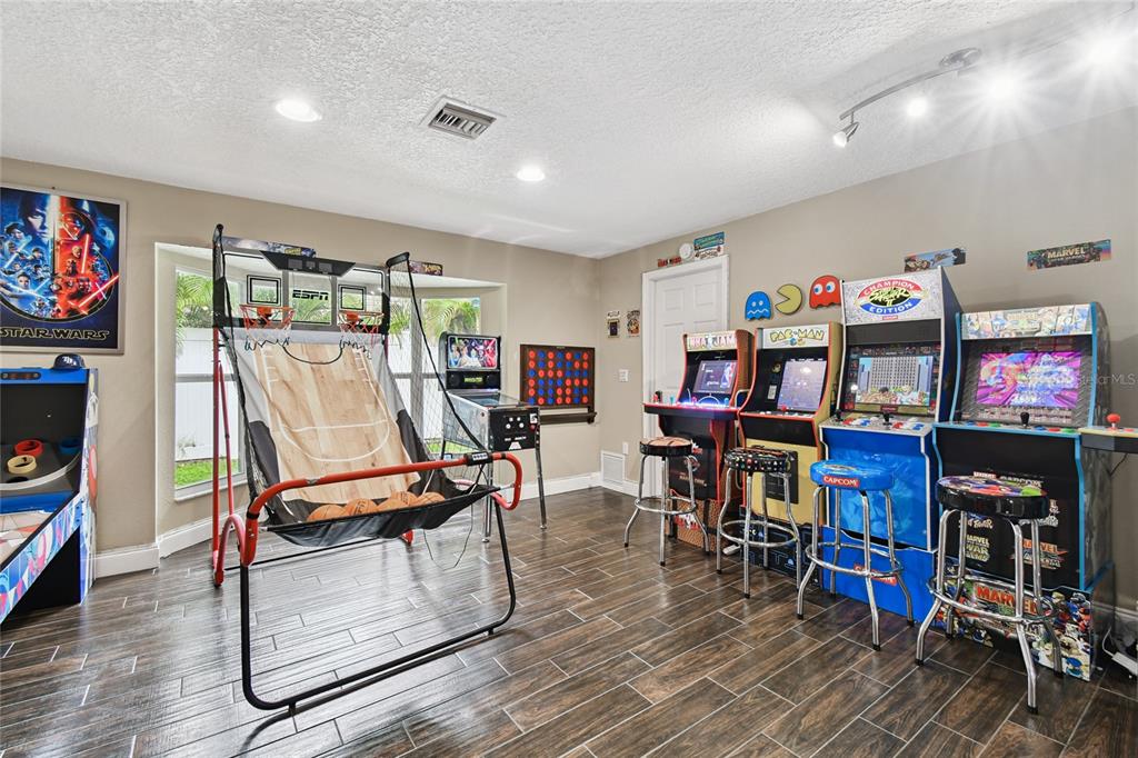 1948 Belleair Road Clearwater, FL 33764 - Photo 48 of 84 a living room with furniture a wooden floor and a flat screen tv