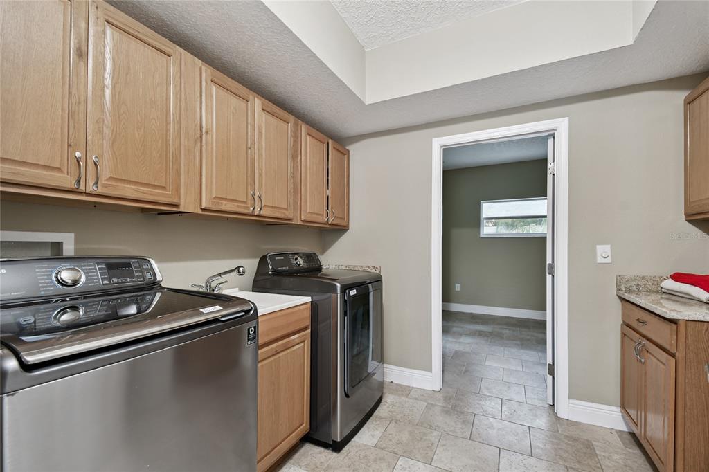 1948 Belleair Road Clearwater, FL 33764 - Photo 52 of 84 a kitchen with stainless steel appliances granite countertop a sink stove and cabinets
