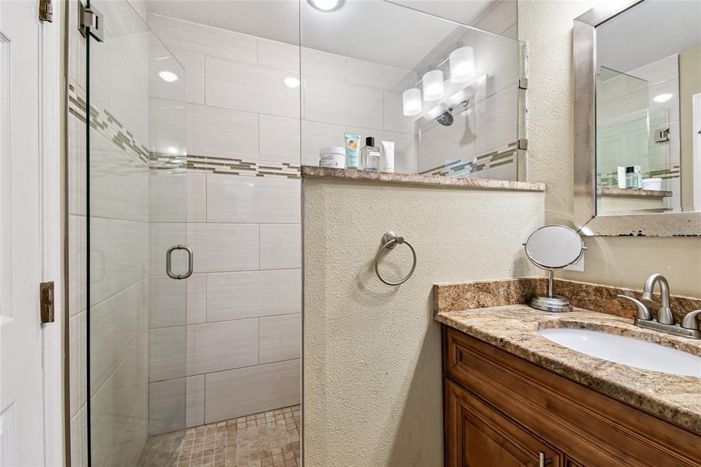 1948 Belleair Road Clearwater, FL 33764 - Photo 66 of 84 a bathroom with a granite countertop sink mirror and vanity
