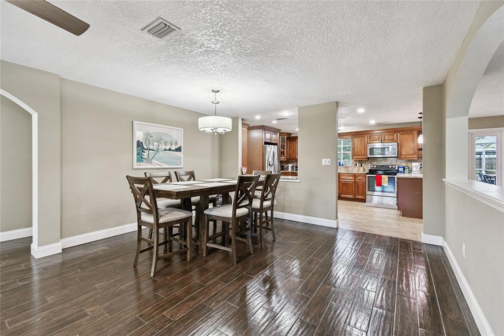 1948 Belleair Road Clearwater, FL 33764 - Photo 9 of 84 a view of a dining room with furniture and wooden floor