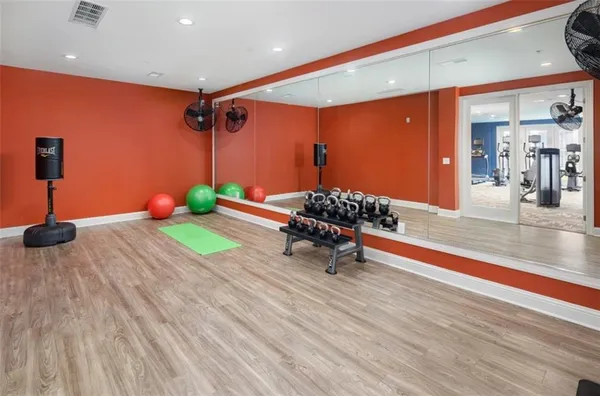 a room with lots of furniture and a wooden floor