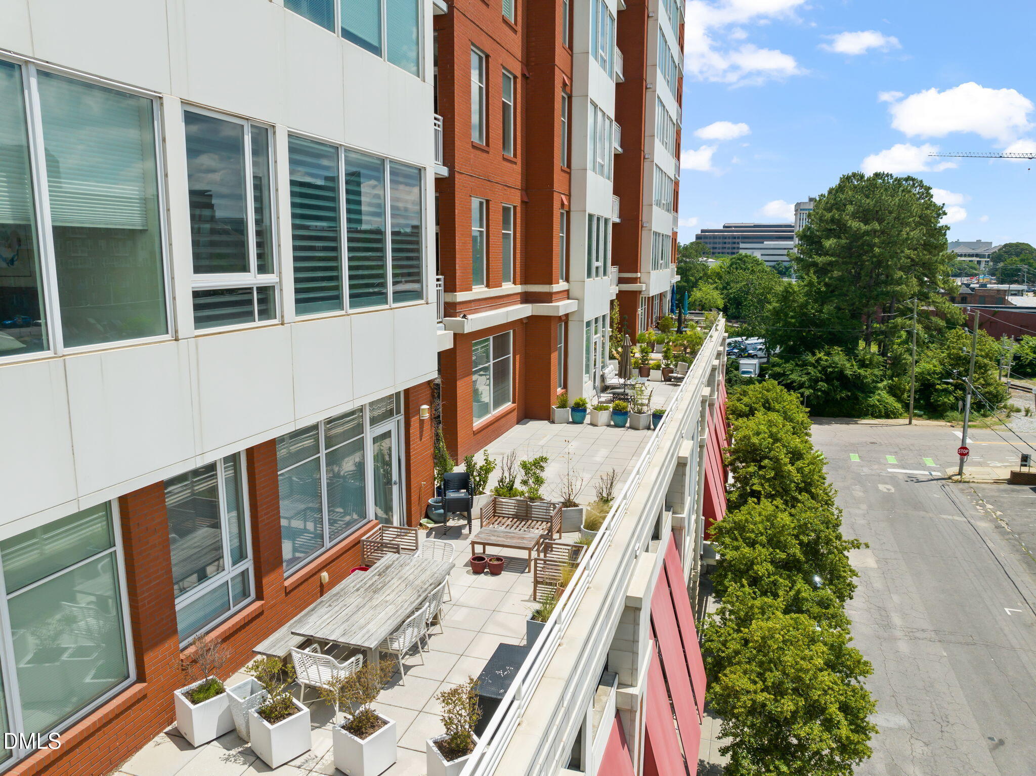 400 West North Street, Unit 1218 Raleigh, NC 27603 - Photo 31 of 41 a view of balcony with a potted plant and floor to ceiling windows