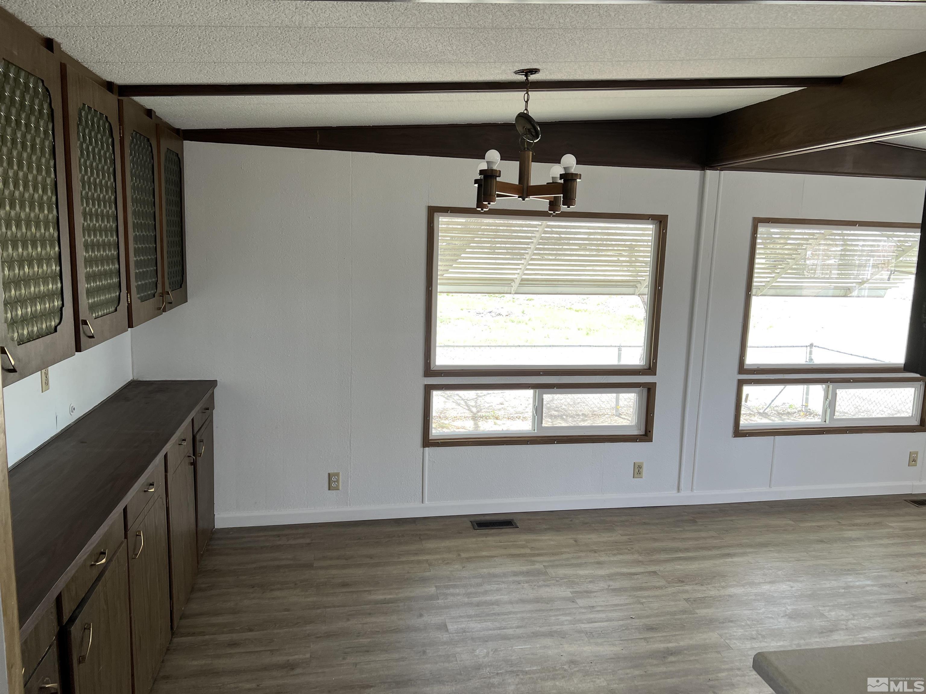 1495 Rice Road Fallon, NV 89406 - Photo 11 of 22 a view of an empty room with a window and wooden floor