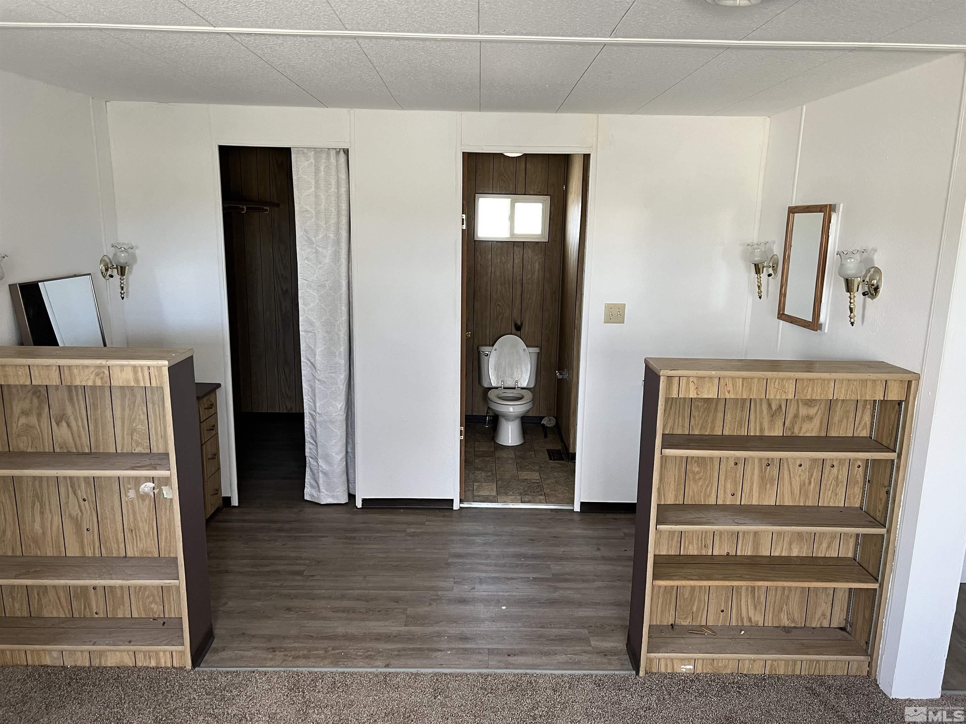 1495 Rice Road Fallon, NV 89406 - Photo 17 of 22 a view of a hallway with wooden floor and cabinet