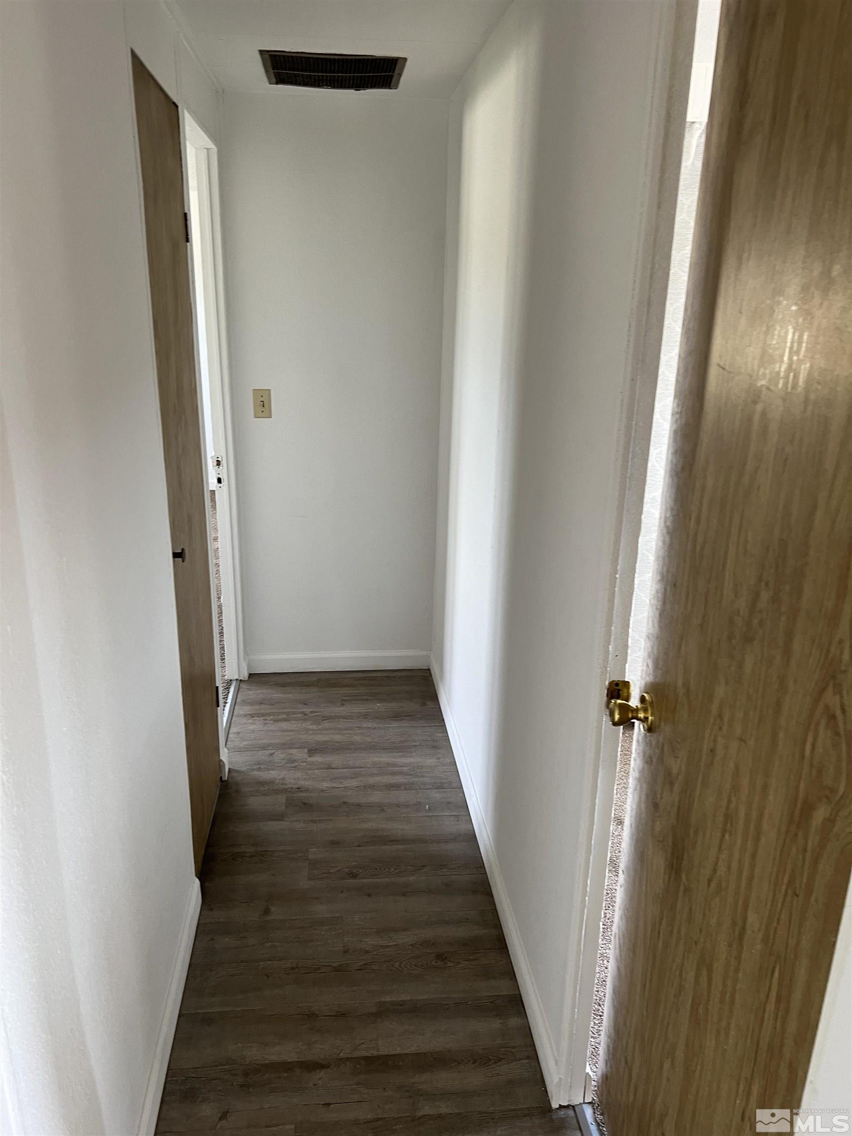 1495 Rice Road Fallon, NV 89406 - Photo 7 of 22 a view of a hallway with wooden floor and staircase