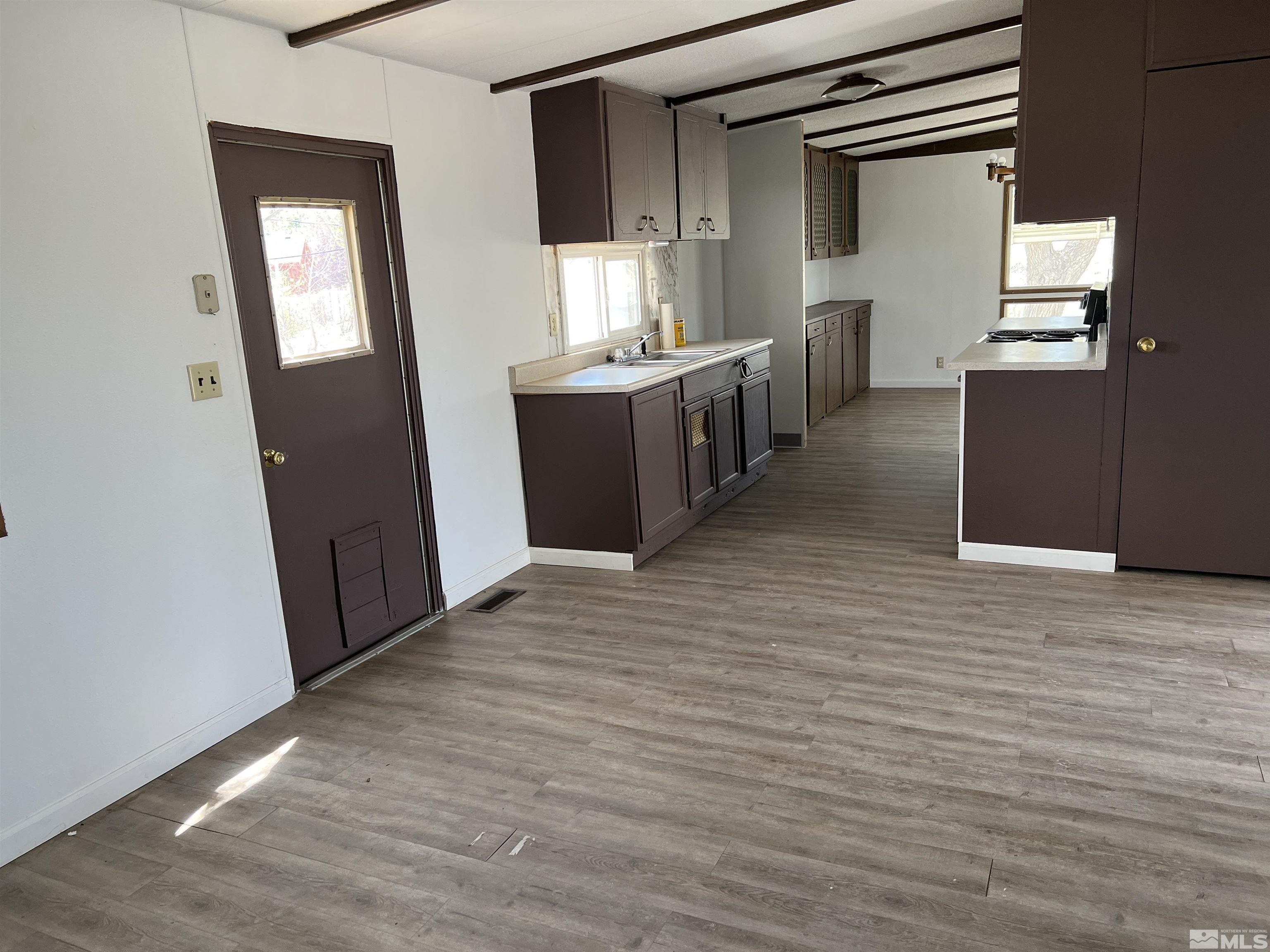 1495 Rice Road Fallon, NV 89406 - Photo 8 of 22 a view of a kitchen cabinets and a wooden floor